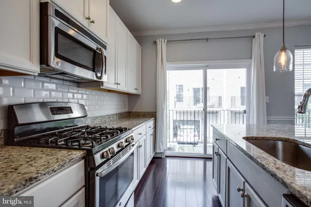 a kitchen with a stove a sink and a microwave