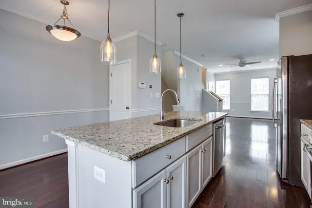 a kitchen with a counter space cabinets and wooden floor