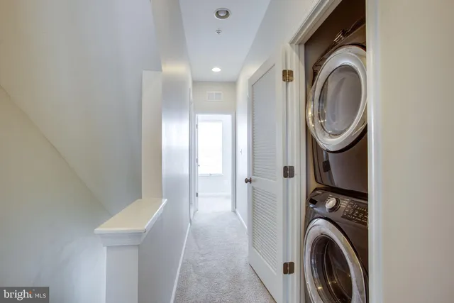 a view of a hallway with washer and dryer