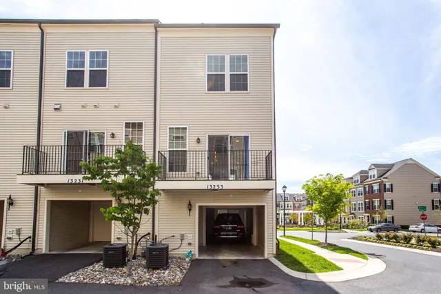 a view of a building with a yard and potted plants