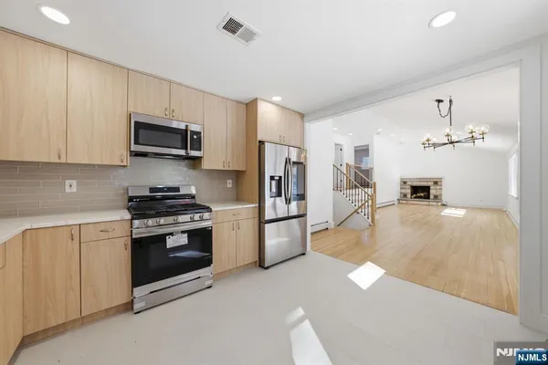 a kitchen with a stove and a refrigerator