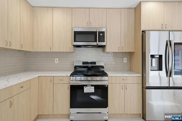 a kitchen with a stove and a refrigerator