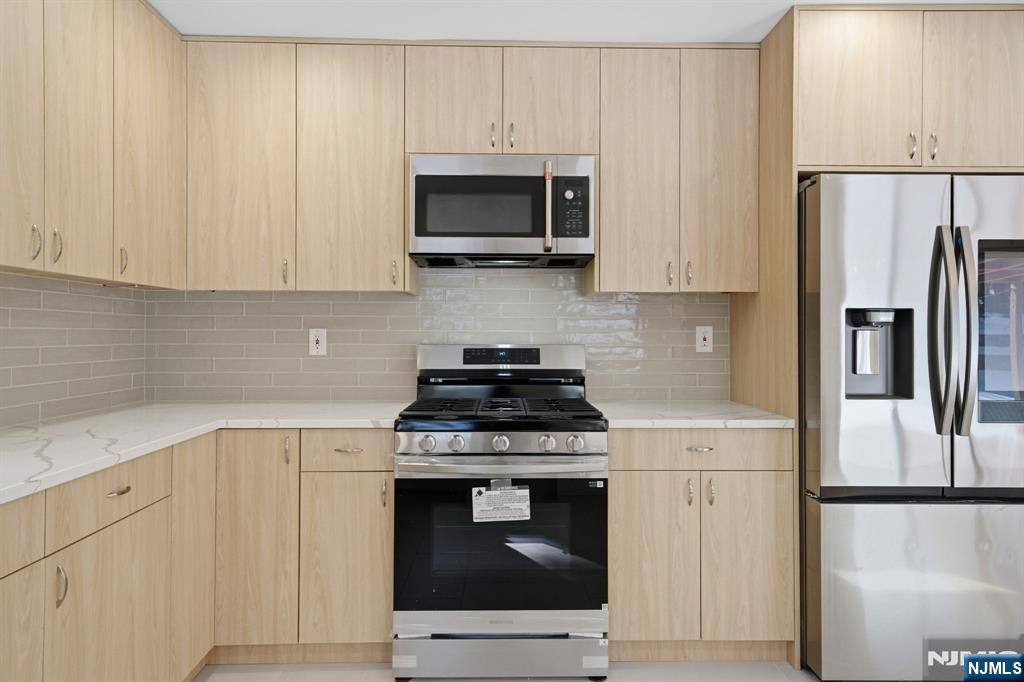 40 Magnolia Avenue Tenafly, NJ 07670 - Photo 15 of 48 a kitchen with a stove and a refrigerator