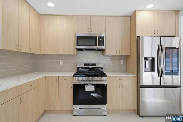 a view of a kitchen with wooden floor and a sink