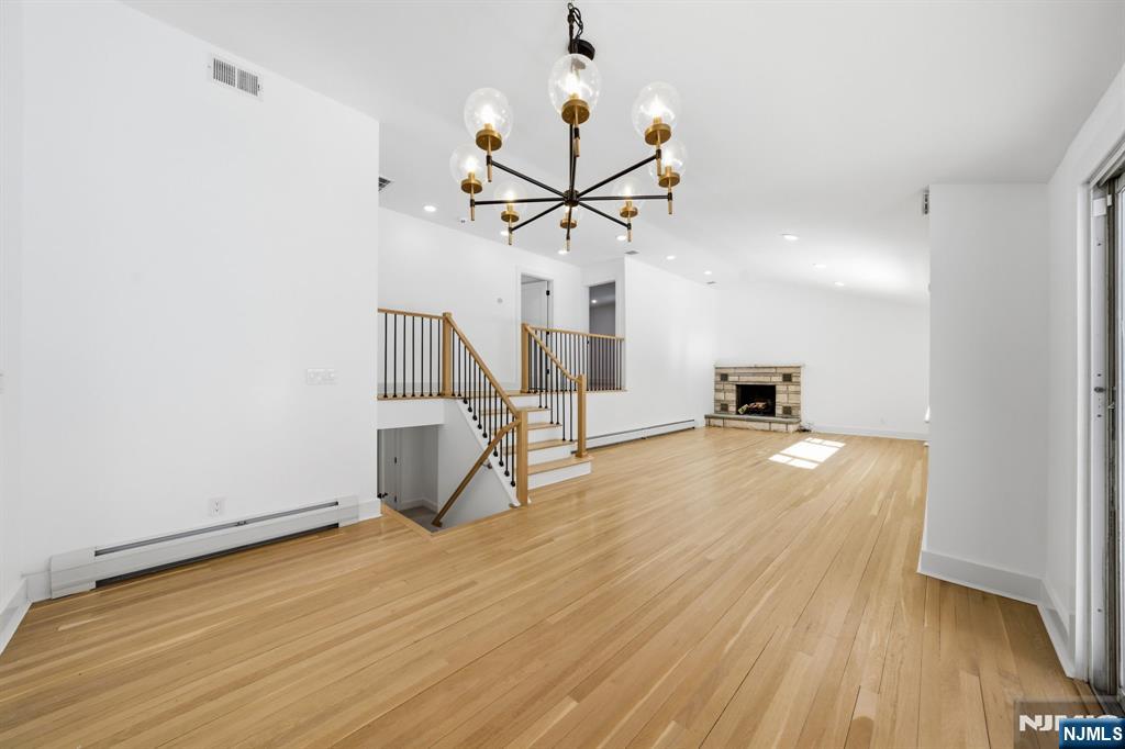 40 Magnolia Avenue Tenafly, NJ 07670 - Photo 18 of 48 a view of a room with wooden floor a ceiling fan and windows
