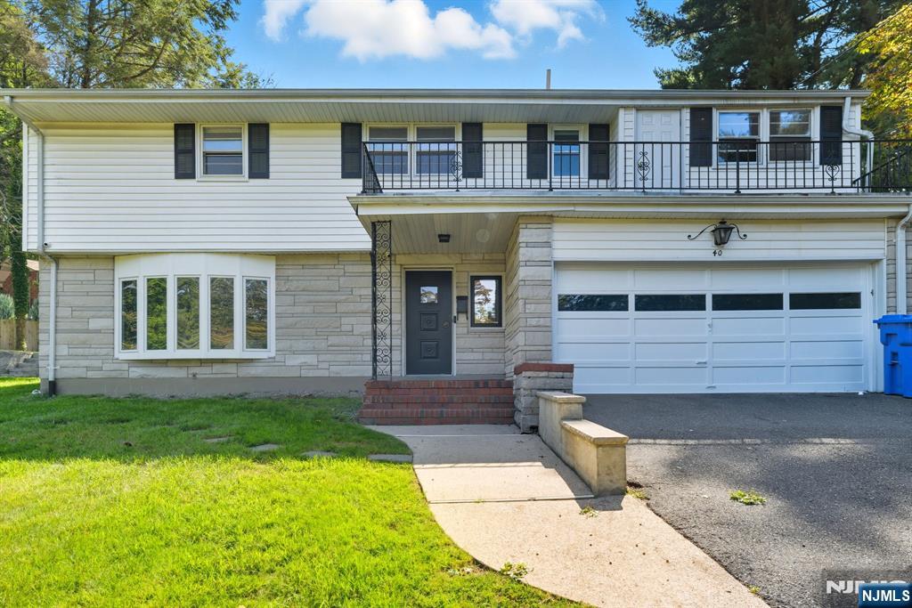 40 Magnolia Avenue Tenafly, NJ 07670 - Photo 2 of 48 a front view of a house with a yard
