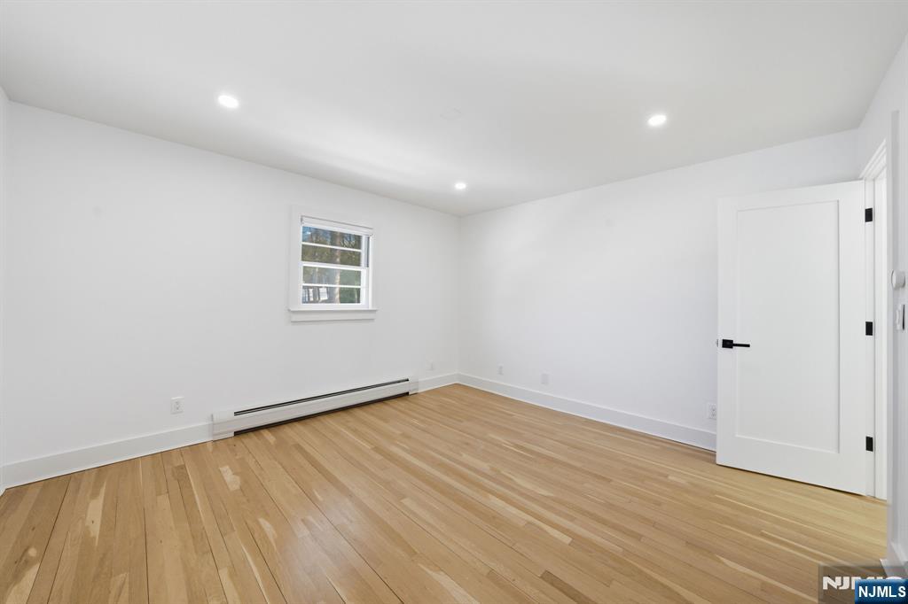 40 Magnolia Avenue Tenafly, NJ 07670 - Photo 25 of 48 a view of an empty room with wooden floor and a window