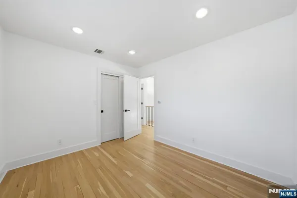 a bathroom with a toilet a sink a mirror and vanity