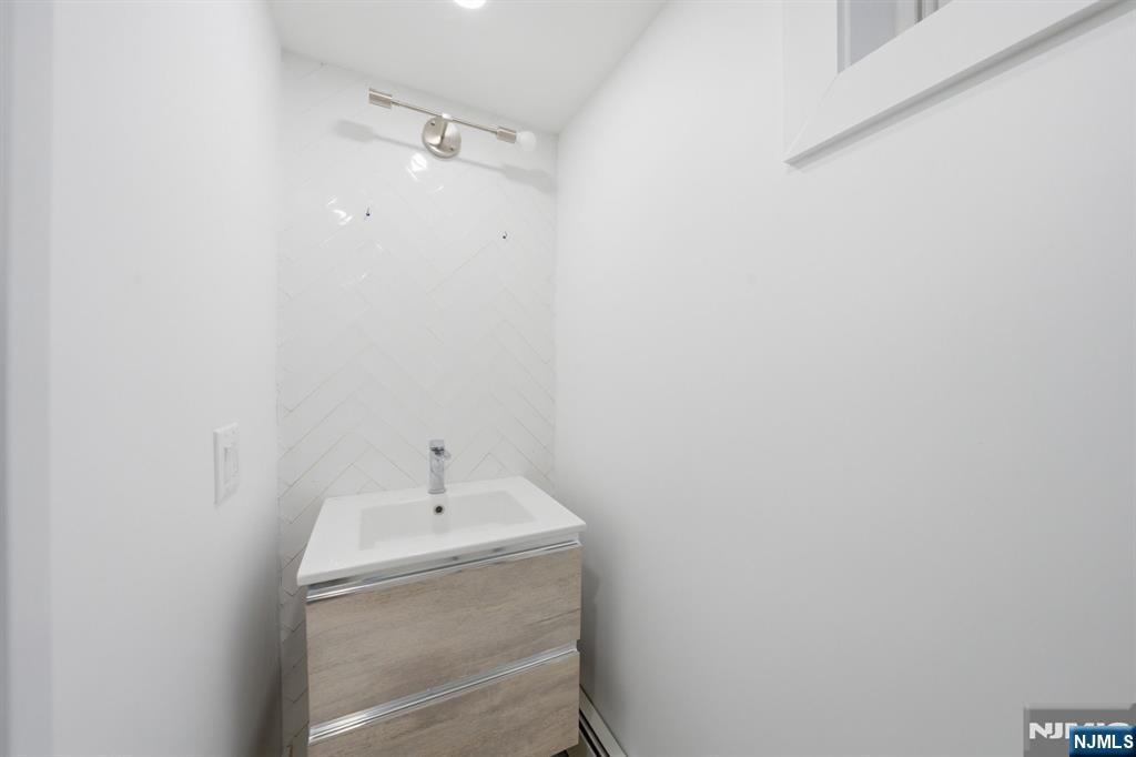 40 Magnolia Avenue Tenafly, NJ 07670 - Photo 42 of 48 a bathroom with a sink and mirror