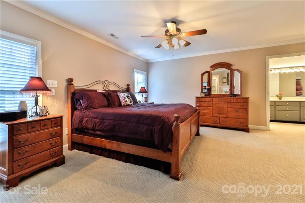 796 Portpatrick Place Fort Mill, SC 29708 - Photo 23 of 48 a bedroom with a bed and a chandelier