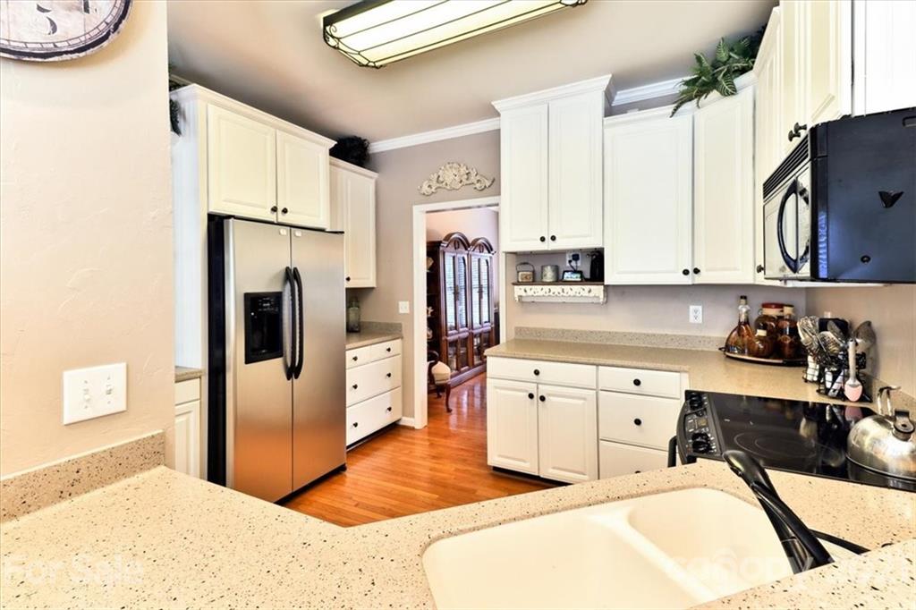 796 Portpatrick Place Fort Mill, SC 29708 - Photo 8 of 48 a kitchen with a refrigerator sink and white cabinets