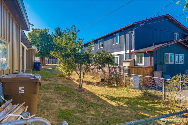 a backyard of a house with table and chairs