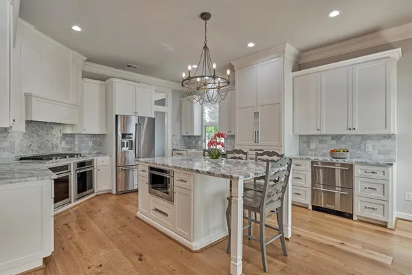 a kitchen with stainless steel appliances a stove sink and refrigerator
