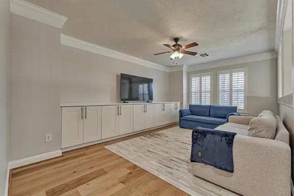 a living room with furniture and a chandelier