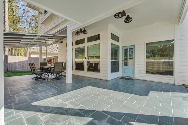 a view of a patio with table and chairs and potted plants
