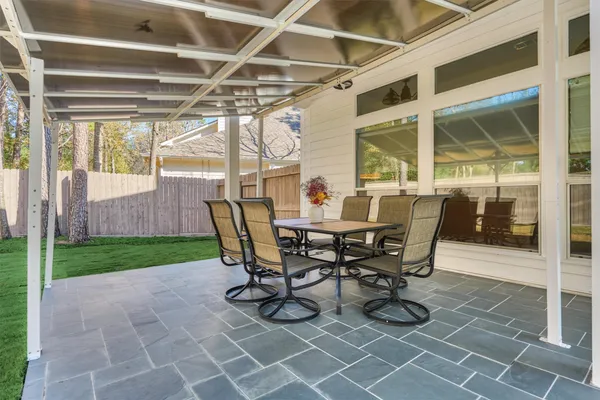 a front view of a house with a yard and sitting area