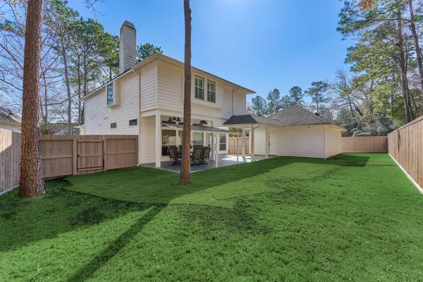 a view of yard with grass and trees
