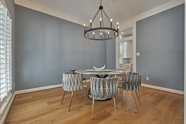 a view of a dining room with furniture wooden floor and chandelier