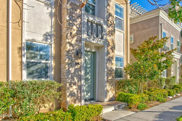 a view of a large building with large windows and flower plants