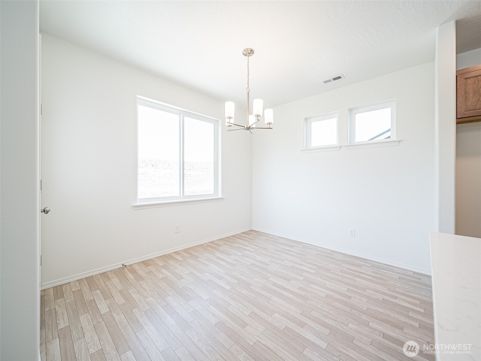 1902 Hickory Road Moses Lake, WA 98837 - Photo 4 of 9 wooden floor in an empty room with a window