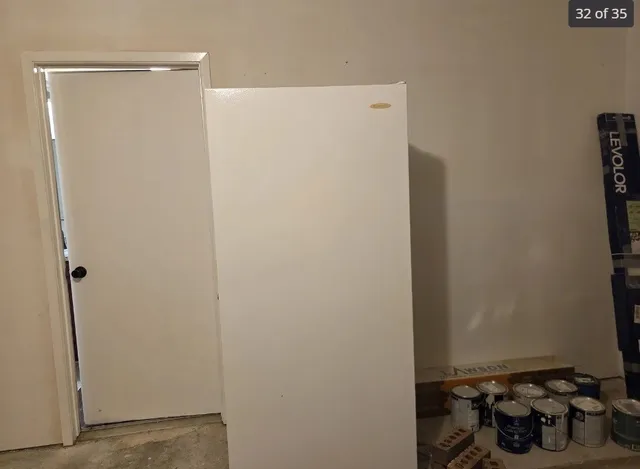 a room with a refrigerator and stove top oven