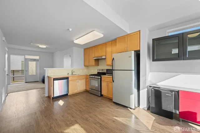 a kitchen with stainless steel appliances granite countertop a refrigerator sink and microwave