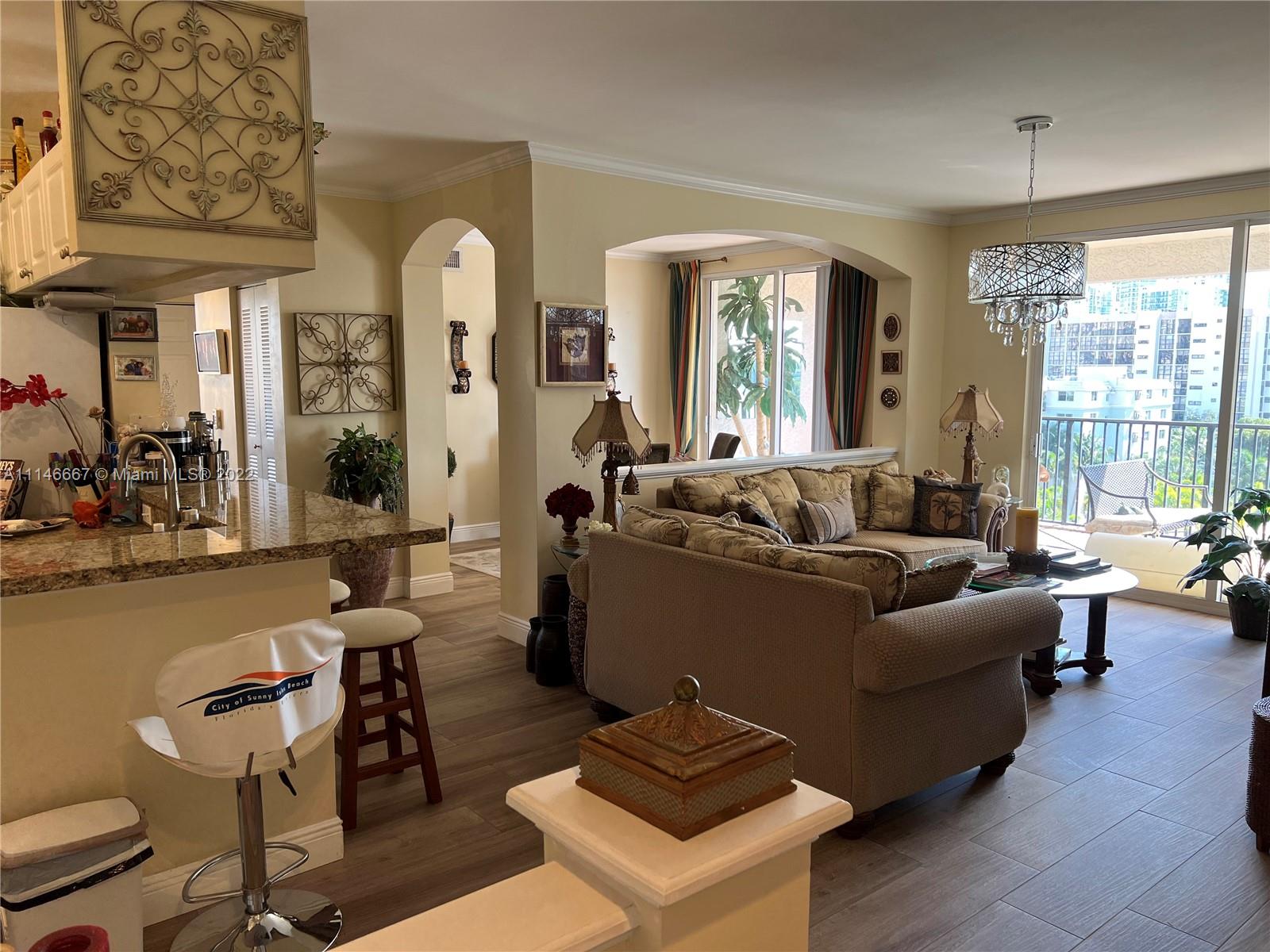 17100 North Bay Road, Unit 1701 Sunny Isles Beach, FL 33160 - Photo 1 of 84 a living room with furniture and a large window