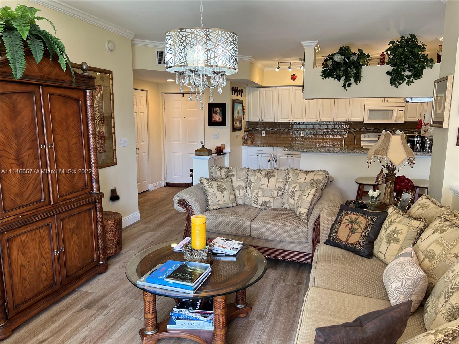 17100 North Bay Road, Unit 1701 Sunny Isles Beach, FL 33160 - Photo 17 of 84 a living room with furniture and a chandelier