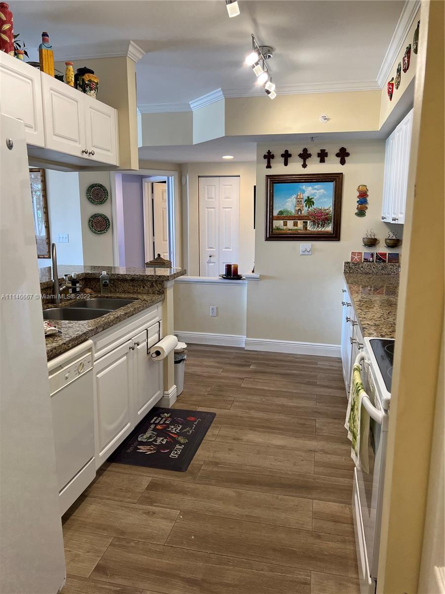 17100 North Bay Road, Unit 1701 Sunny Isles Beach, FL 33160 - Photo 19 of 84 a kitchen with a refrigerator and a stove