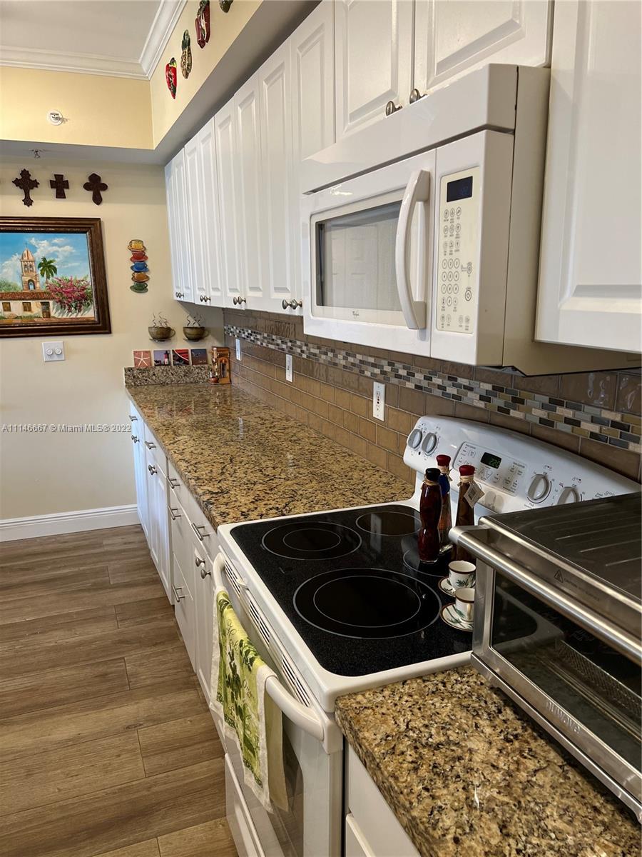 17100 North Bay Road, Unit 1701 Sunny Isles Beach, FL 33160 - Photo 23 of 84 a kitchen that has a sink and a stove