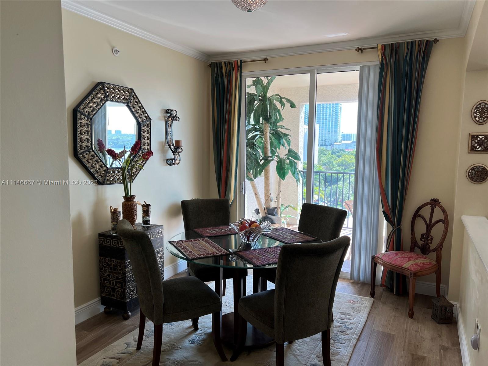 17100 North Bay Road, Unit 1701 Sunny Isles Beach, FL 33160 - Photo 25 of 84 a view of a dining room with furniture and a large window