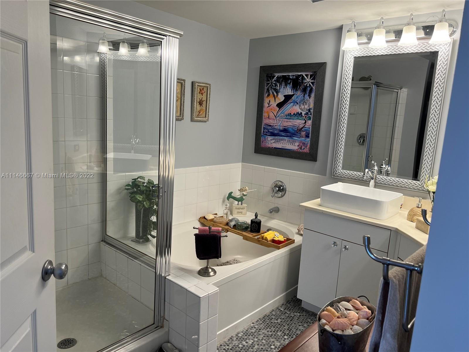 17100 North Bay Road, Unit 1701 Sunny Isles Beach, FL 33160 - Photo 32 of 84 a bathroom with a sink mirror and toilet