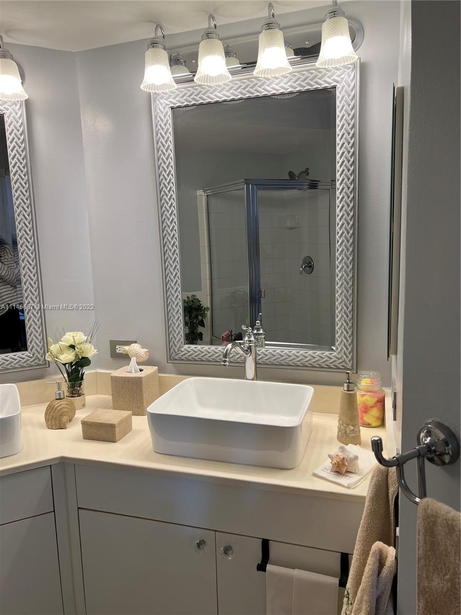 17100 North Bay Road, Unit 1701 Sunny Isles Beach, FL 33160 - Photo 34 of 84 a bathroom with a sink and a mirror