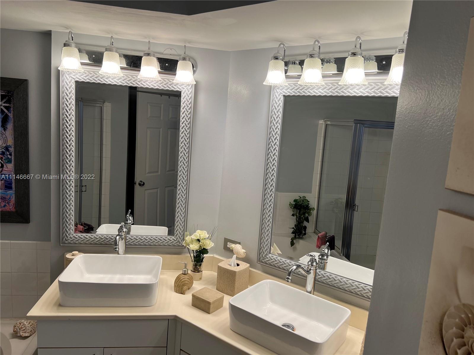 17100 North Bay Road, Unit 1701 Sunny Isles Beach, FL 33160 - Photo 35 of 84 a bathroom with a sink and a mirror