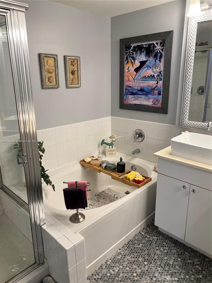 17100 North Bay Road, Unit 1701 Sunny Isles Beach, FL 33160 - Photo 37 of 84 a bathroom with a sink a mirror and a toilet