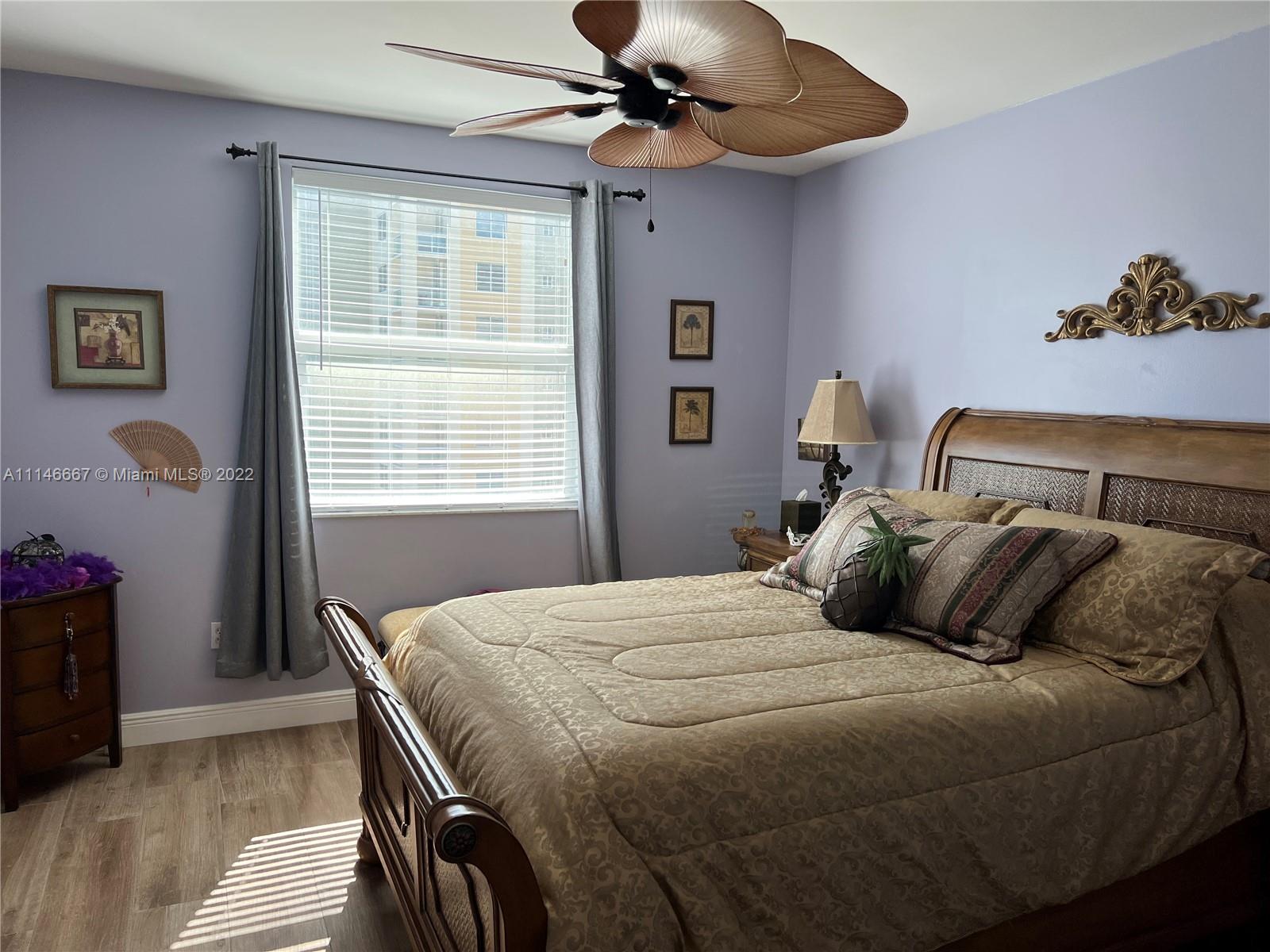 17100 North Bay Road, Unit 1701 Sunny Isles Beach, FL 33160 - Photo 41 of 84 a bedroom with a bed and a chandelier
