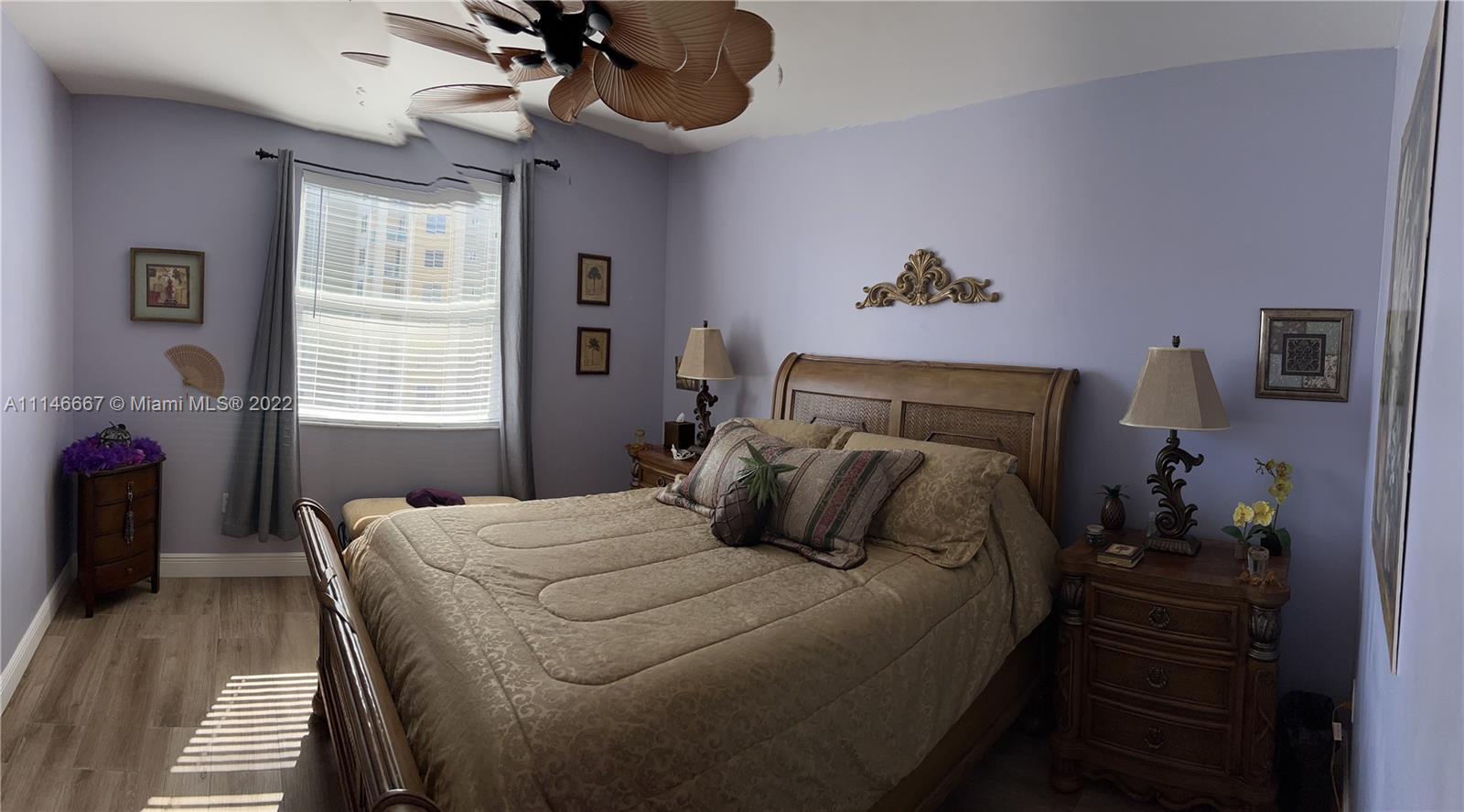 17100 North Bay Road, Unit 1701 Sunny Isles Beach, FL 33160 - Photo 44 of 84 a bedroom with a bed and a chandelier