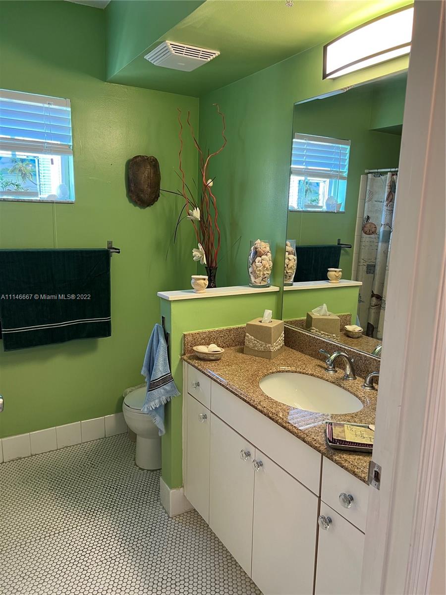 17100 North Bay Road, Unit 1701 Sunny Isles Beach, FL 33160 - Photo 50 of 84 a bathroom with a granite countertop sink and a mirror