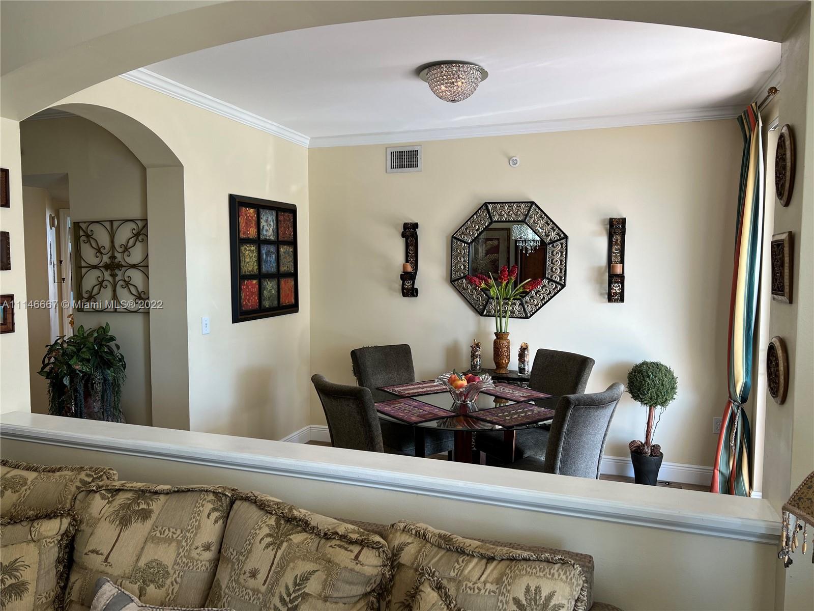 17100 North Bay Road, Unit 1701 Sunny Isles Beach, FL 33160 - Photo 5 of 84 a living room with furniture and a large mirror