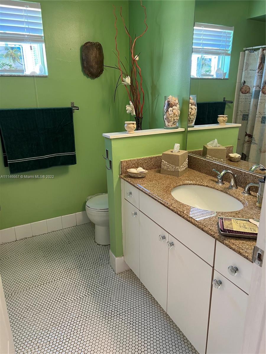 17100 North Bay Road, Unit 1701 Sunny Isles Beach, FL 33160 - Photo 51 of 84 a bathroom with a sink a toilet and mirror