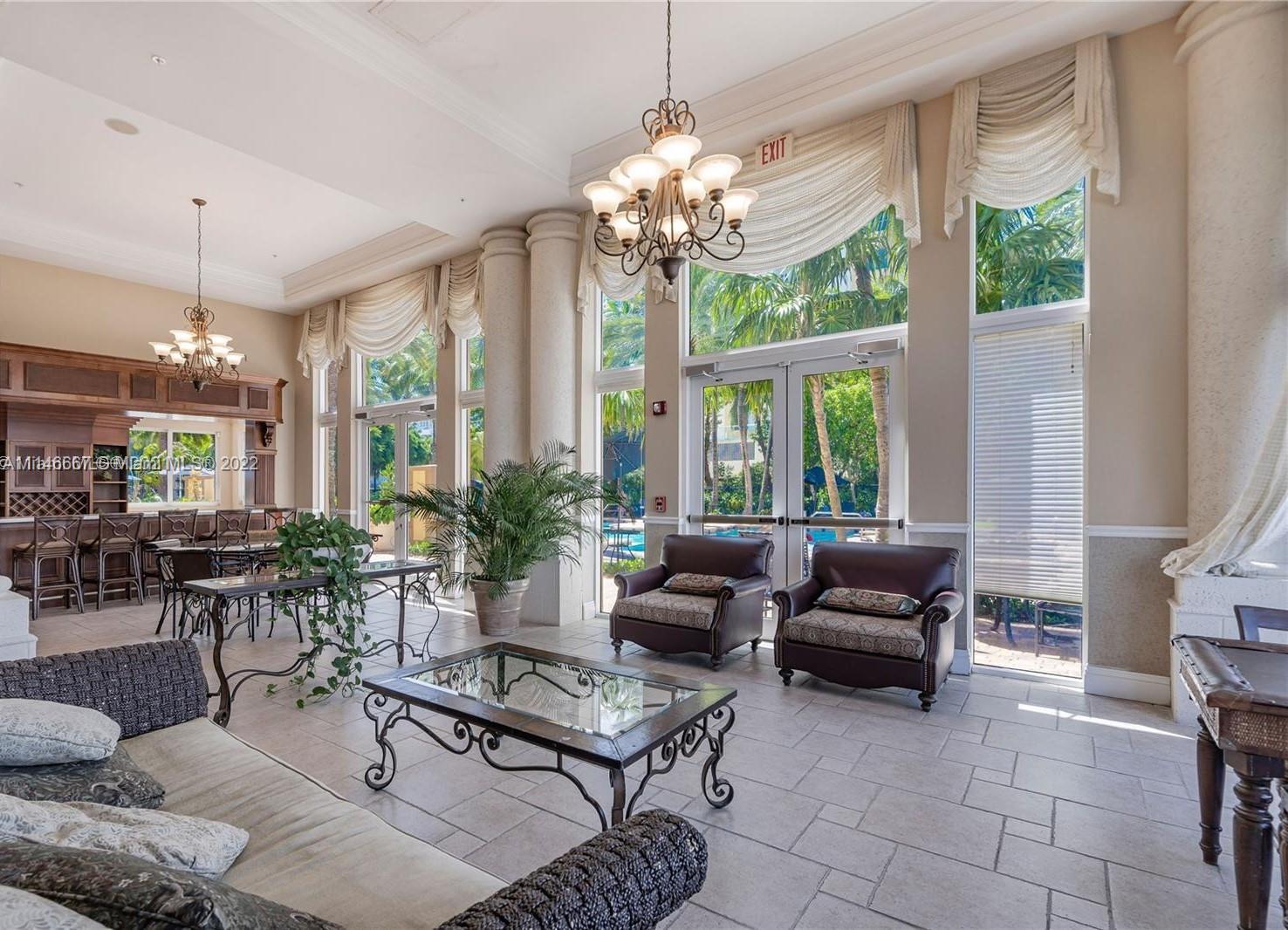 17100 North Bay Road, Unit 1701 Sunny Isles Beach, FL 33160 - Photo 72 of 84 a living room with patio furniture and a chandelier