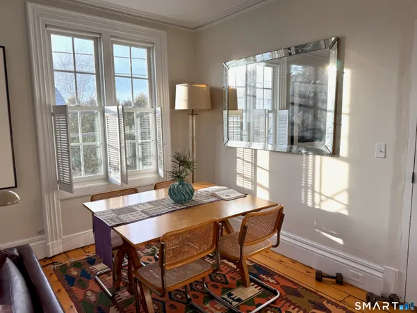 a dining room with furniture and window