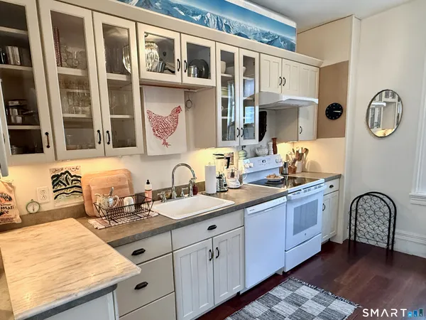 a spacious bathroom with a granite countertop sink and a mirror