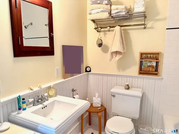 a white toilet sitting next to a bathroom sink