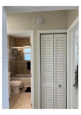 a bedroom with a bed dresser and a window