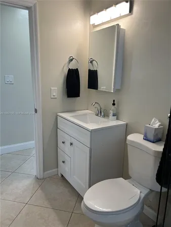 a view of a hallway with wooden cabinets