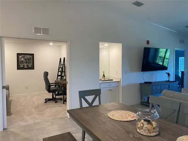 a work room with furniture and a flat screen tv
