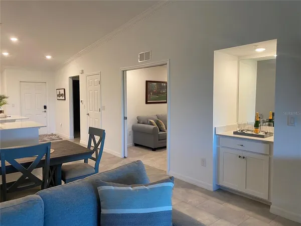 a living room with furniture and a chandelier