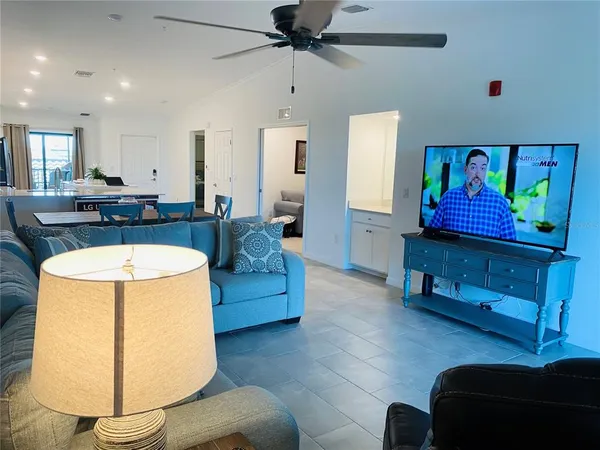 a living room with furniture and a lamp