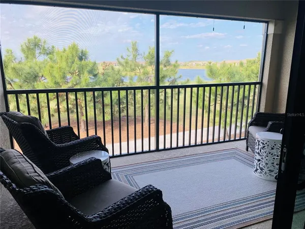 a balcony with furniture and a potted plant